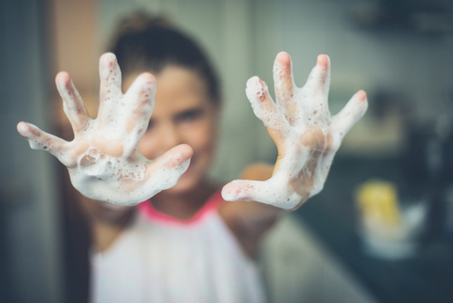 Girl with foamy soap on hands