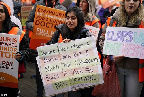 NHS junior doctors take part in a march and rally in the centre of Birmingham on April 14, with a sign saying: 'Would have made a bigger sign but I needed the cardboard boxes ro pack for New Zealand'